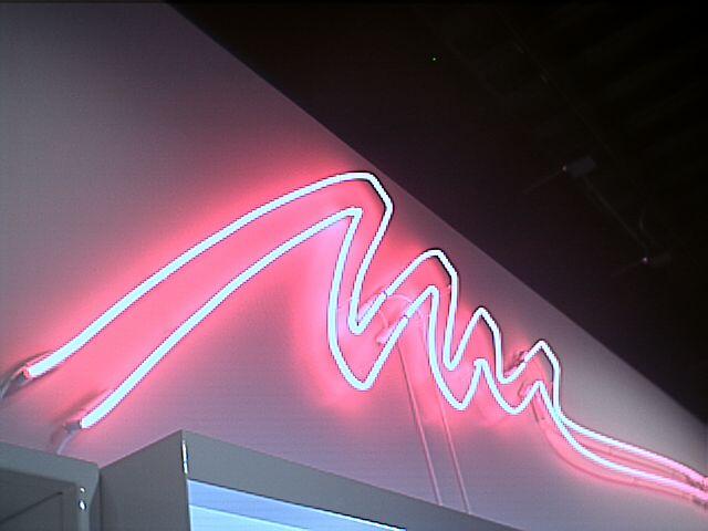 A pink neon squiggly sign, reminiscent of the Jazz Solo cup design from the 90s.